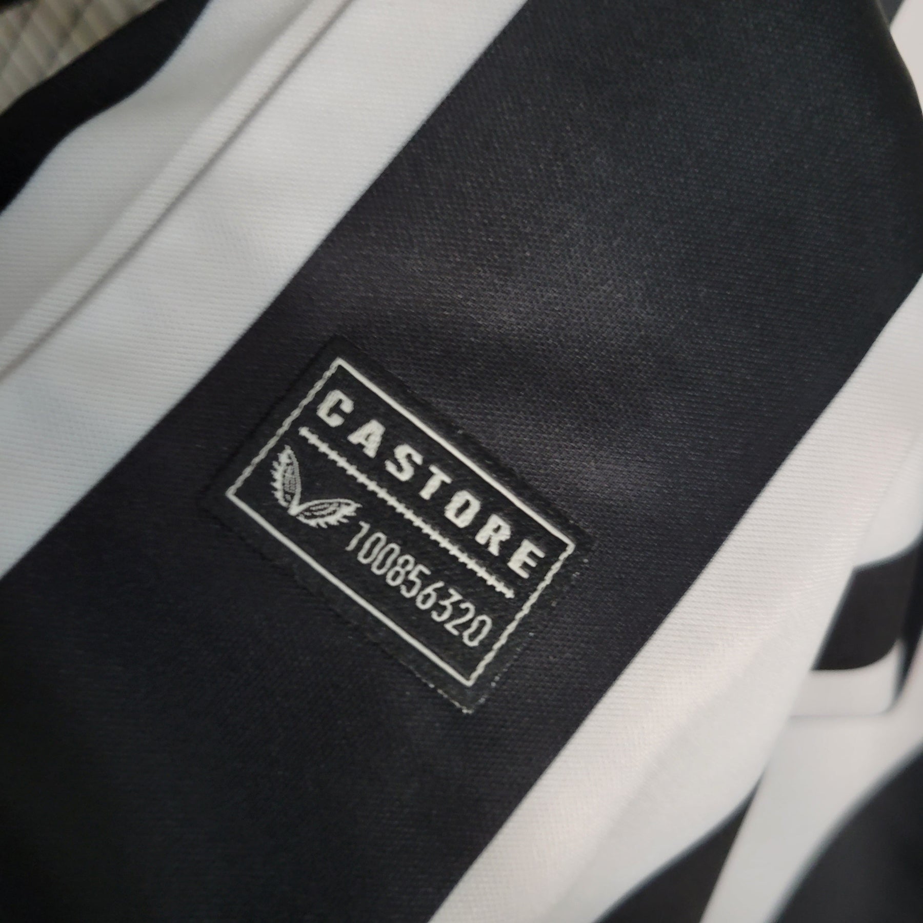 Camisa NewCastle Home 2023/24 - Castore Torcedor Masculina - Preta/Branca