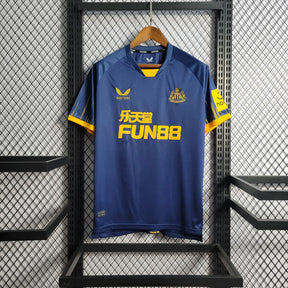 Camisa Newcastle Away 2023/24 - Castore Torcedor Masculino - Azul/Amarela